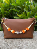 Hebrew Shell, Ilima, Pua Kalaunu, and Pikake Bag Lei